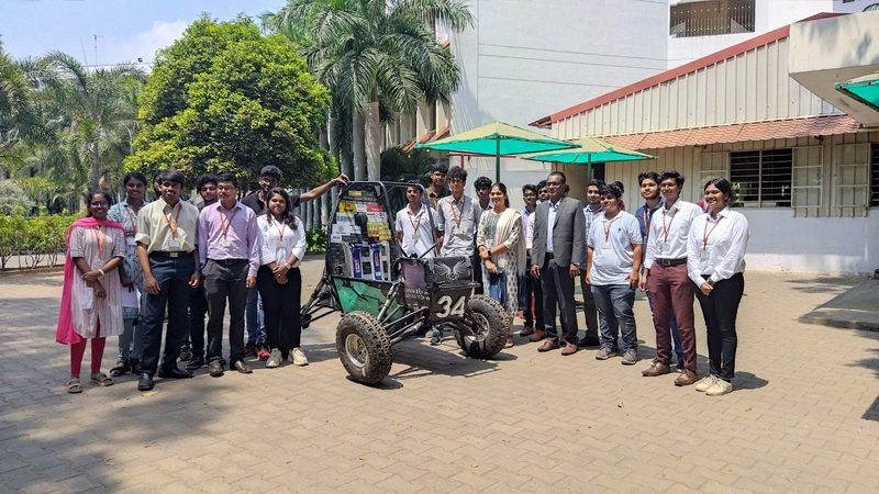 Baja team lined up with their green ATV