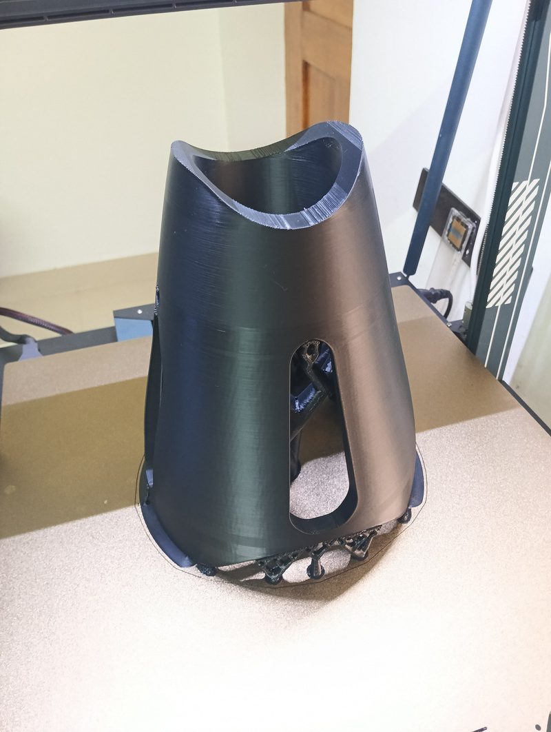 Black 3D-printed conical duct on the printer bed