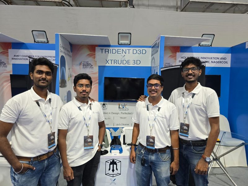 Four people at the XTRUDE3D exhibition stand